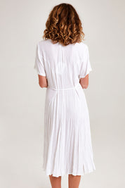 Model Emma wearing size 10 of the Essentials Godet Short Sleeve Dress in colour White (White), from the back