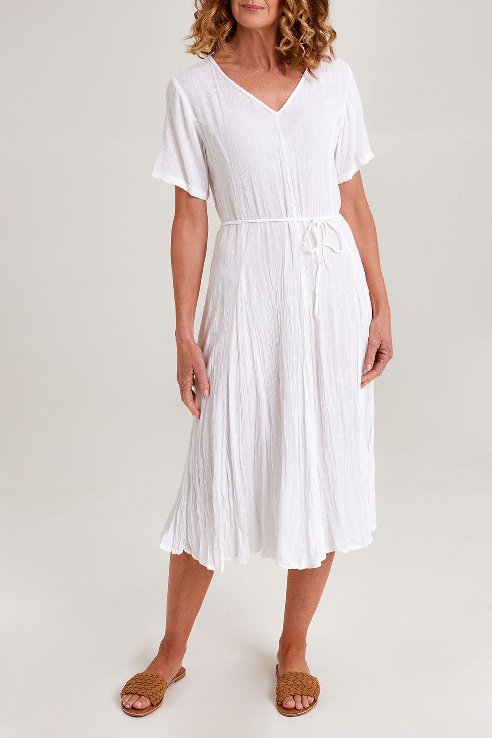 Model Emma wearing size 10 of the Essentials Godet Short Sleeve Dress in colour White (White), from the front, cropped image