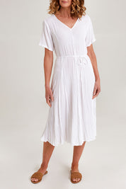 Model Emma wearing size 10 of the Essentials Godet Short Sleeve Dress in colour White (White), from the front, cropped image
