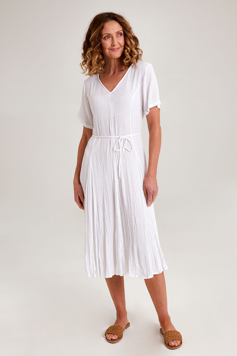 Model Emma wearing size 10 of the Essentials Godet Short Sleeve Dress in colour White (White), from the front, showing the whole outfit