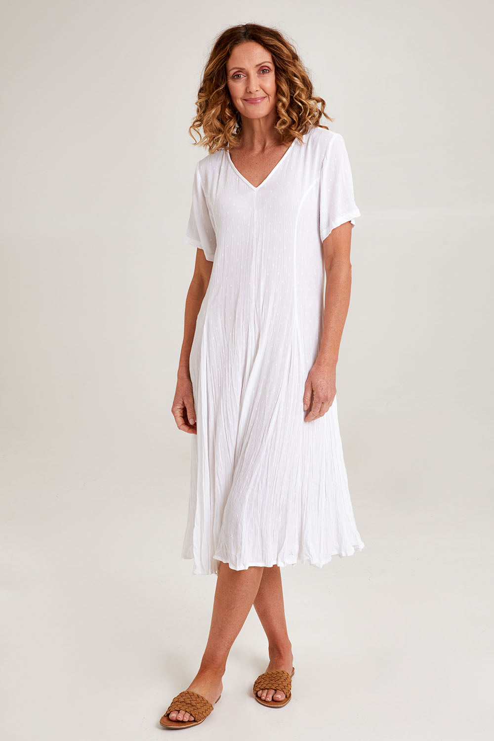 Model Emma wearing size 10 of the Essentials Godet Short Sleeve Dress in colour White (White), from the front, showing the whole outfit