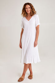 Model Emma wearing size 10 of the Essentials Godet Short Sleeve Dress in colour White (White), from the front, showing the whole outfit