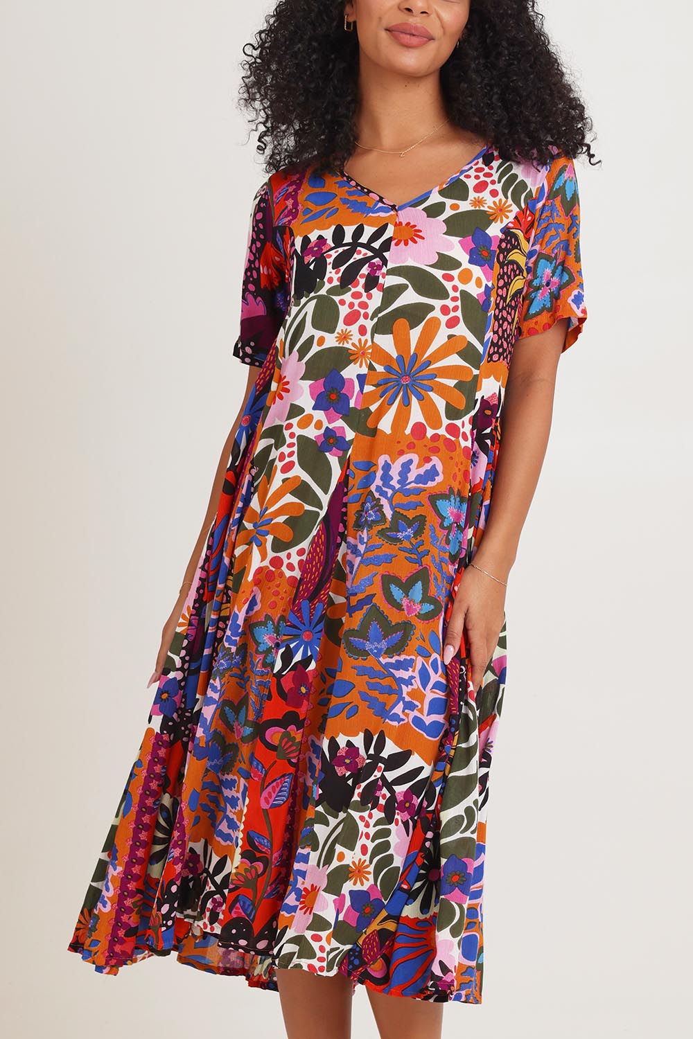 Model Ziara wearing size 10 of the Salvador Short Sleeve Godet Dress in colour Print, from the front, cropped image