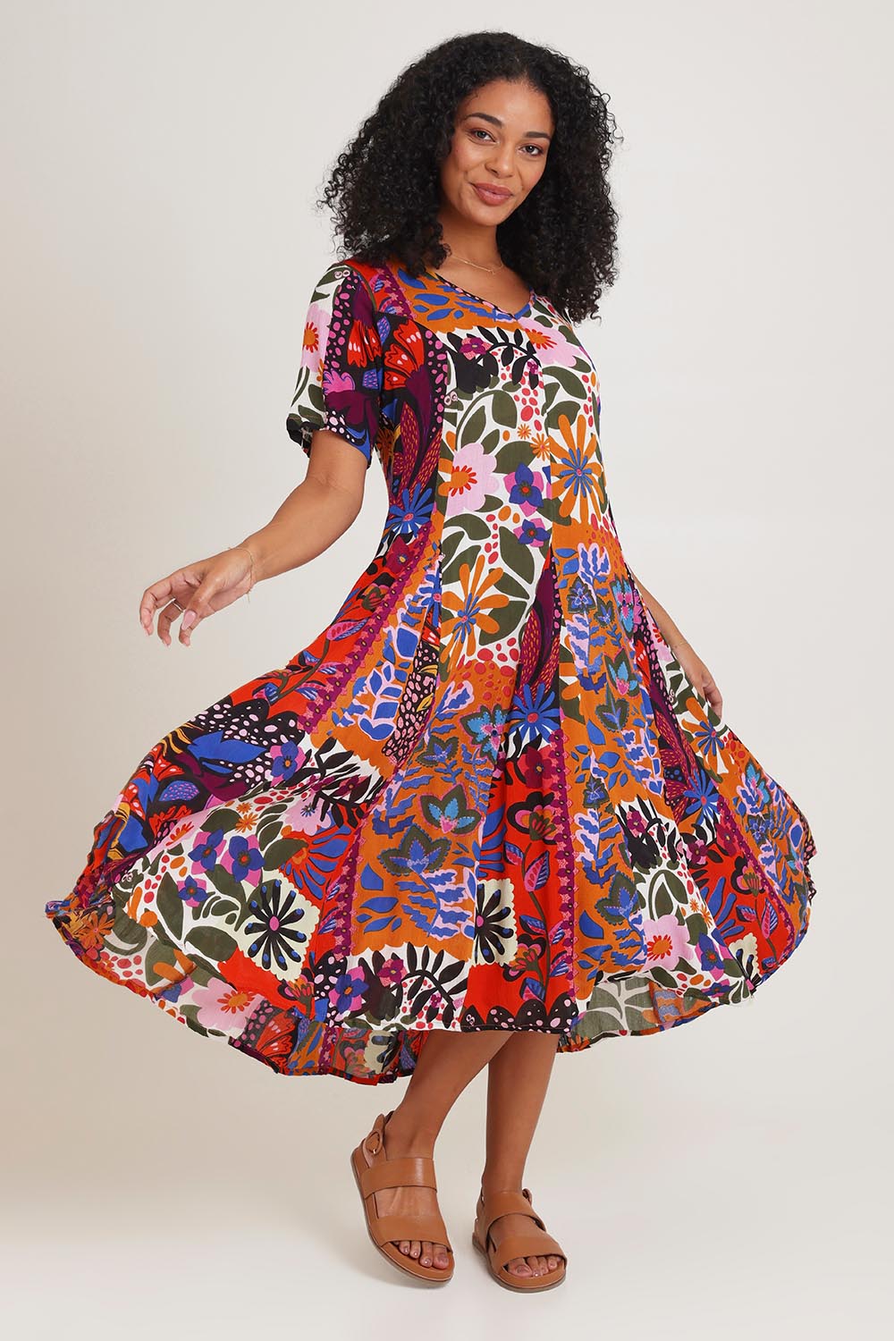 Model Ziara wearing size 10 of the Salvador Short Sleeve Godet Dress in colour Print, from the front, showing the whole outfit
