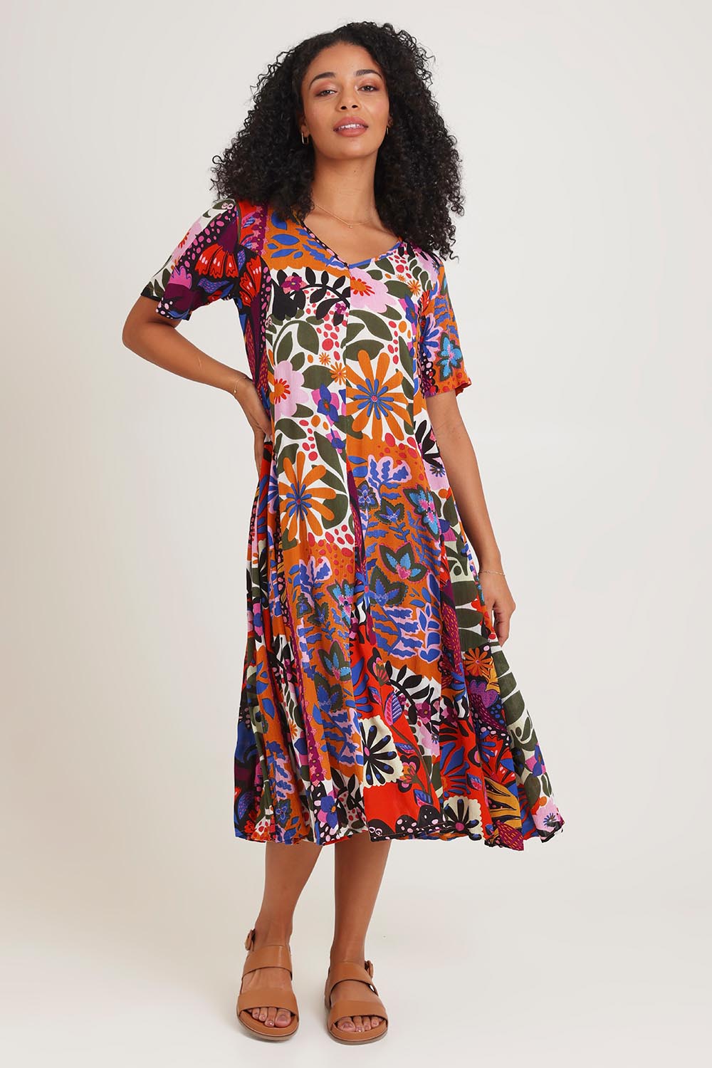 Model Ziara wearing size 10 of the Salvador Short Sleeve Godet Dress in colour Print, from the front, showing the whole outfit