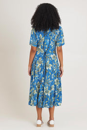 Model Ziara wearing size 10 of the Short Sleeve Godet Dress in colour Miramar, from the back