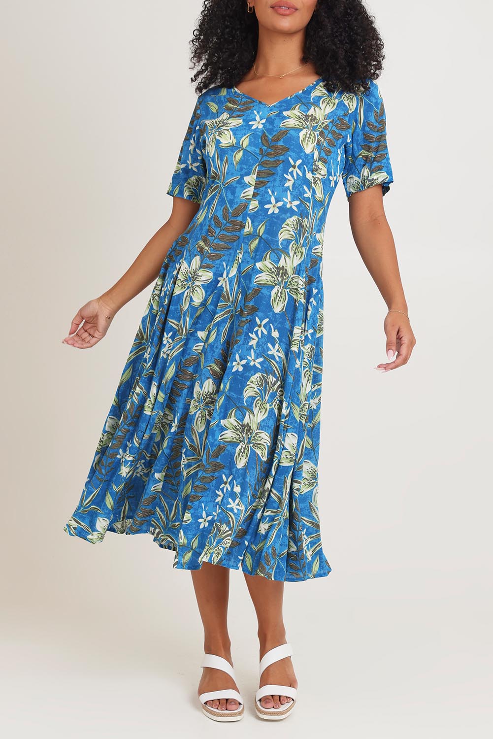 Model Ziara wearing size 10 of the Short Sleeve Godet Dress in colour Miramar, from the front, cropped image