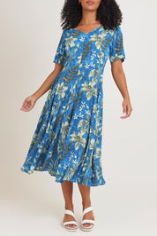 Model Ziara wearing size 10 of the Short Sleeve Godet Dress in colour Miramar, from the front, cropped image