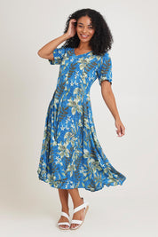 Model Ziara wearing size 10 of the Short Sleeve Godet Dress in colour Miramar, from the front, showing the whole outfit