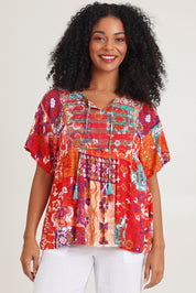 Model Ziara wearing size 10 of the Bib Top in colour Araya, from the front, cropped image