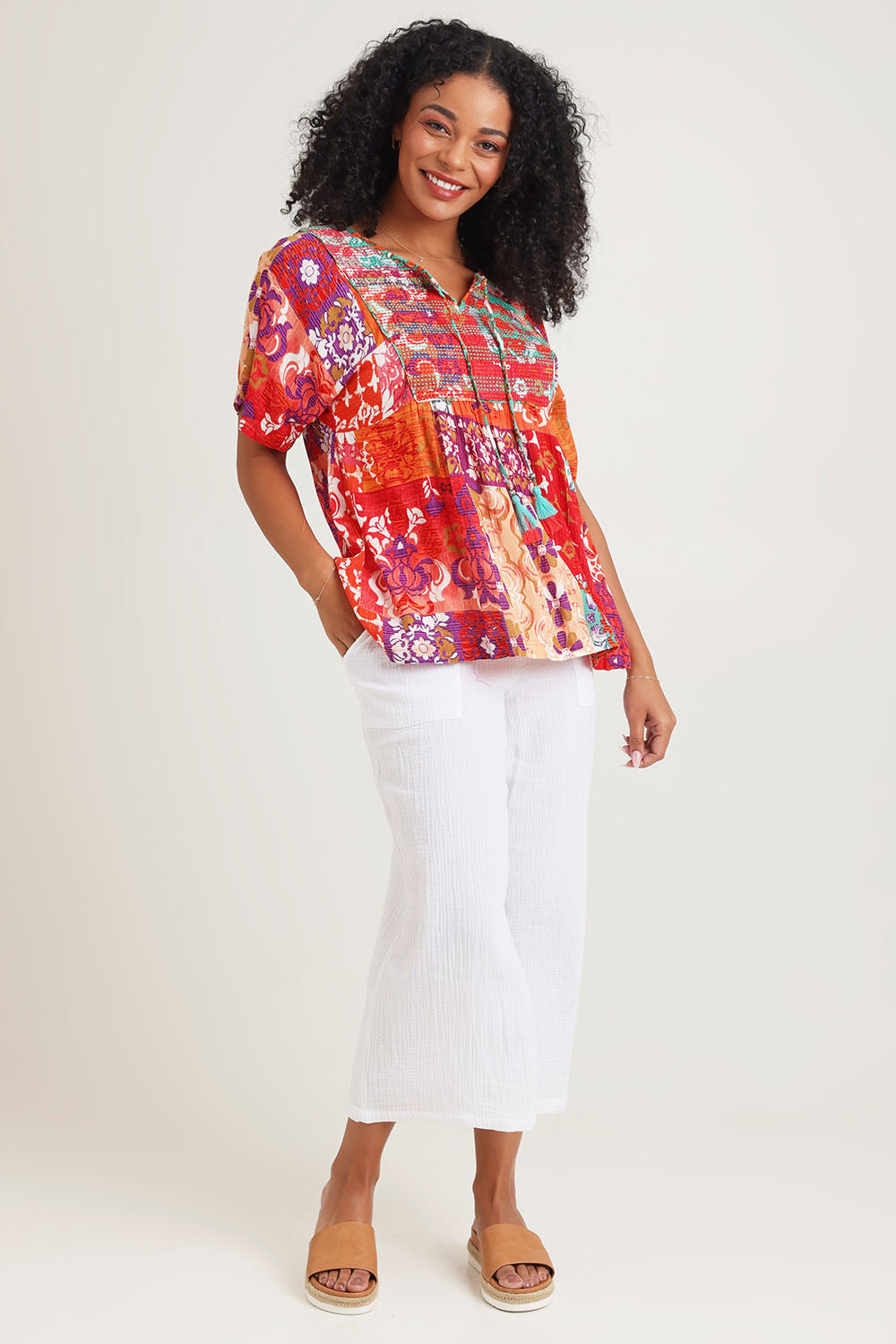 Model Ziara wearing size 10 of the Bib Top in colour Araya, from the front, showing the whole outfit