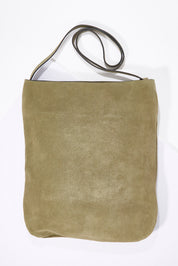 A model wearing size OneSize of the Suede Slouchy Bag in colour Olive (Green), from the front, showing the whole outfit