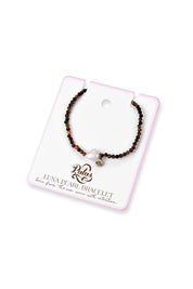 Product shot of the Luna Pearl Bracelet - Tigerseye in colour Tigerseye, from the back