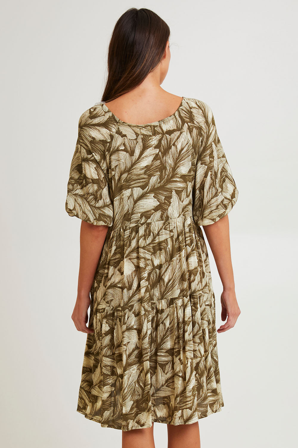 Model Madeline wearing size S of the Crinkle Dress in colour Leaves (Green), from the back