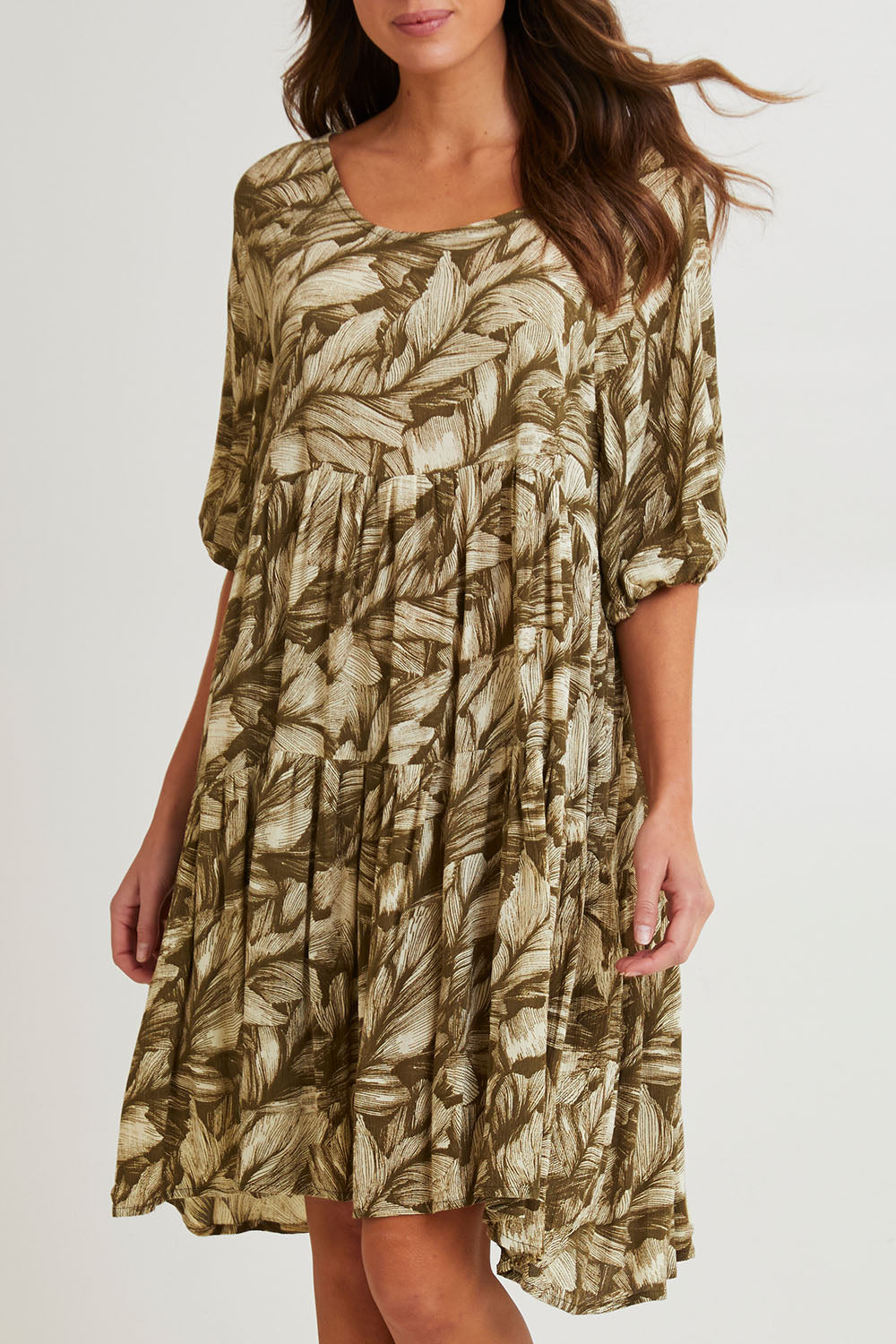 Model Madeline wearing size S of the Crinkle Dress in colour Leaves (Green), from the front, cropped image