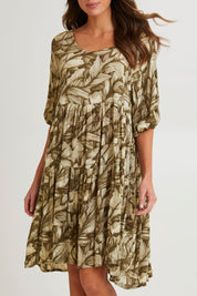 Model Madeline wearing size S of the Crinkle Dress in colour Leaves (Green), from the front, cropped image