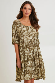 Model Madeline wearing size S of the Crinkle Dress in colour Leaves (Green), from the front, cropped image
