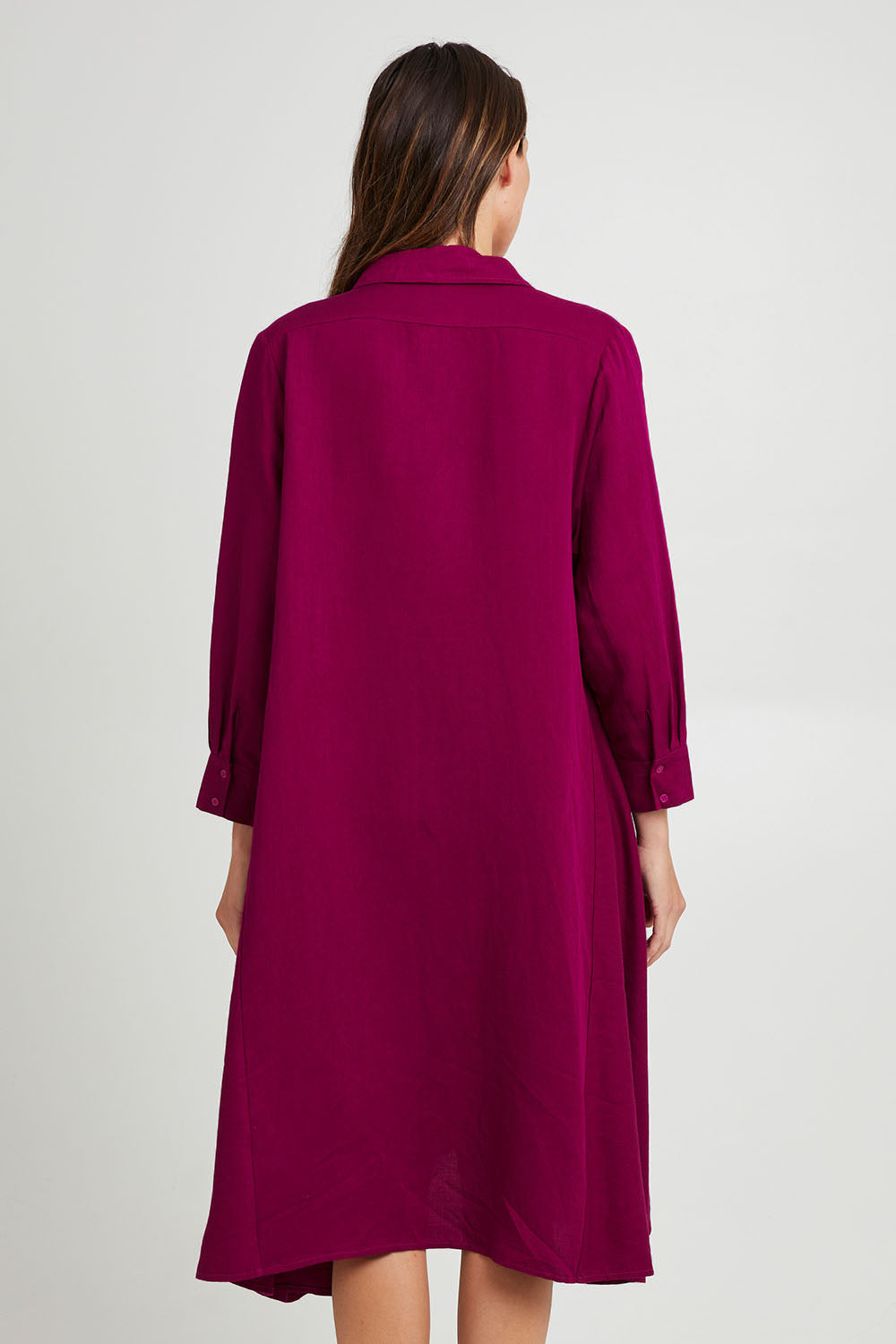 Model Madeline wearing the Cadillia Dress in colour Deepplum (Pink), from the back