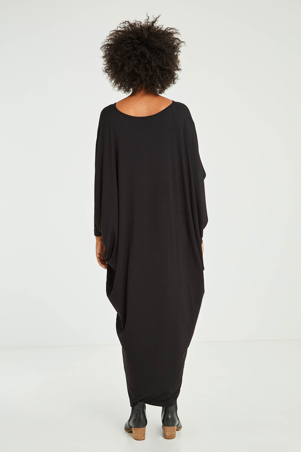 Model Olivia wearing size OneSize of the Long Sleeve Maxi Miracle Dress in colour Black (Black), from the back