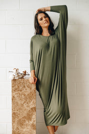 A model wearing the Long Sleeve Maxi Miracle Dress in colour Khaki (Green), from the front, showing the whole outfit