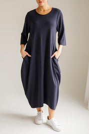 A model wearing the Alviva Lounge Dress in colour Navy (Blue), from the front, cropped image