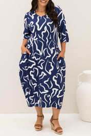 A model wearing the Alviva Bamboo Dress in colour Seaport (Blue), from the front, cropped image