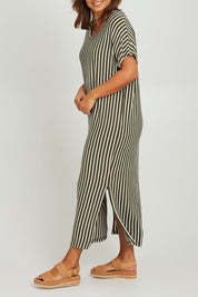 Model Monique wearing the Destiny Dress in colour Green (Green), from the front, cropped image