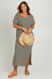 Model Monique wearing the Destiny Dress in colour Green (Green), from the front, showing the whole outfit
