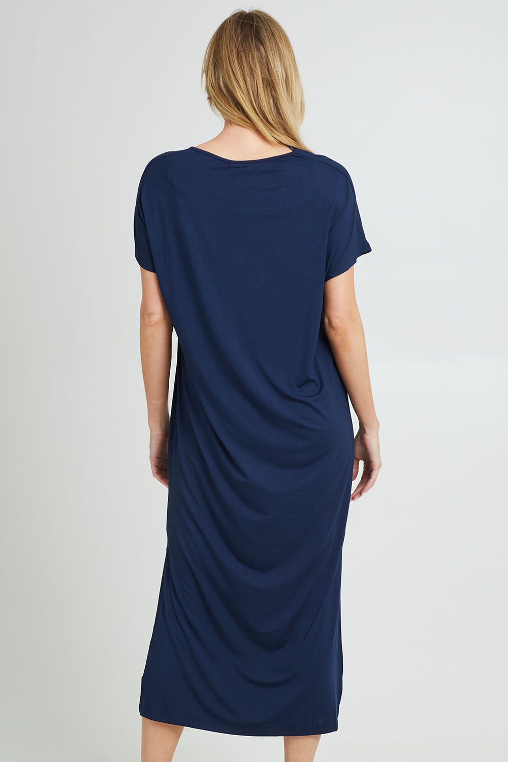 Model Grace wearing the Destiny Round Neck Dress in colour Navy (Blue), from the back