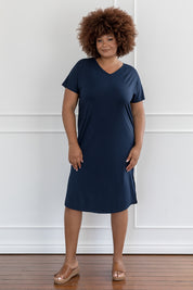 A model wearing the Fate V Neck Dress in colour Navy (Blue), from the front, showing the whole outfit