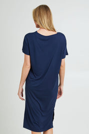 Model Grace wearing the Fate V Neck Dress in colour Navy (Blue), from the back