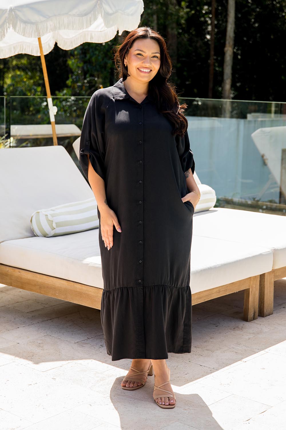 A model wearing the Cora Tencel Dress in colour Black (Black), from the front, showing the whole outfit
