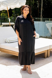 A model wearing the Cora Tencel Dress in colour Black (Black), from the front, showing the whole outfit