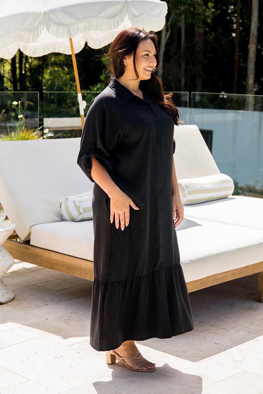 A model wearing the Cora Tencel Dress in colour Black (Black), from the front, showing the whole outfit