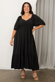 A model wearing the Austin Midi Tencel Blend Dress in colour Black (Black), from the front, showing the whole outfit