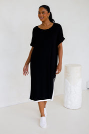 A model wearing the Gigi Lounge Dress in colour Black (Black), from the front, showing the whole outfit