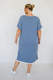 A model wearing the Gigi Lounge Dress in colour Dusk (Blue), from the back
