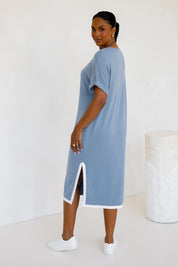 A model wearing the Gigi Lounge Dress in colour Dusk (Blue), from the back