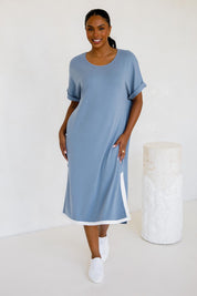 A model wearing the Gigi Lounge Dress in colour Dusk (Blue), from the front, showing the whole outfit