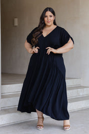 A model wearing the Short Sleeve Peak Maxi Dress in colour Black (Black), from the front, showing the whole outfit