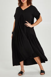Model Maddy wearing the Short Sleeve Peak Maxi Dress in colour Black (Black), from the front, cropped image