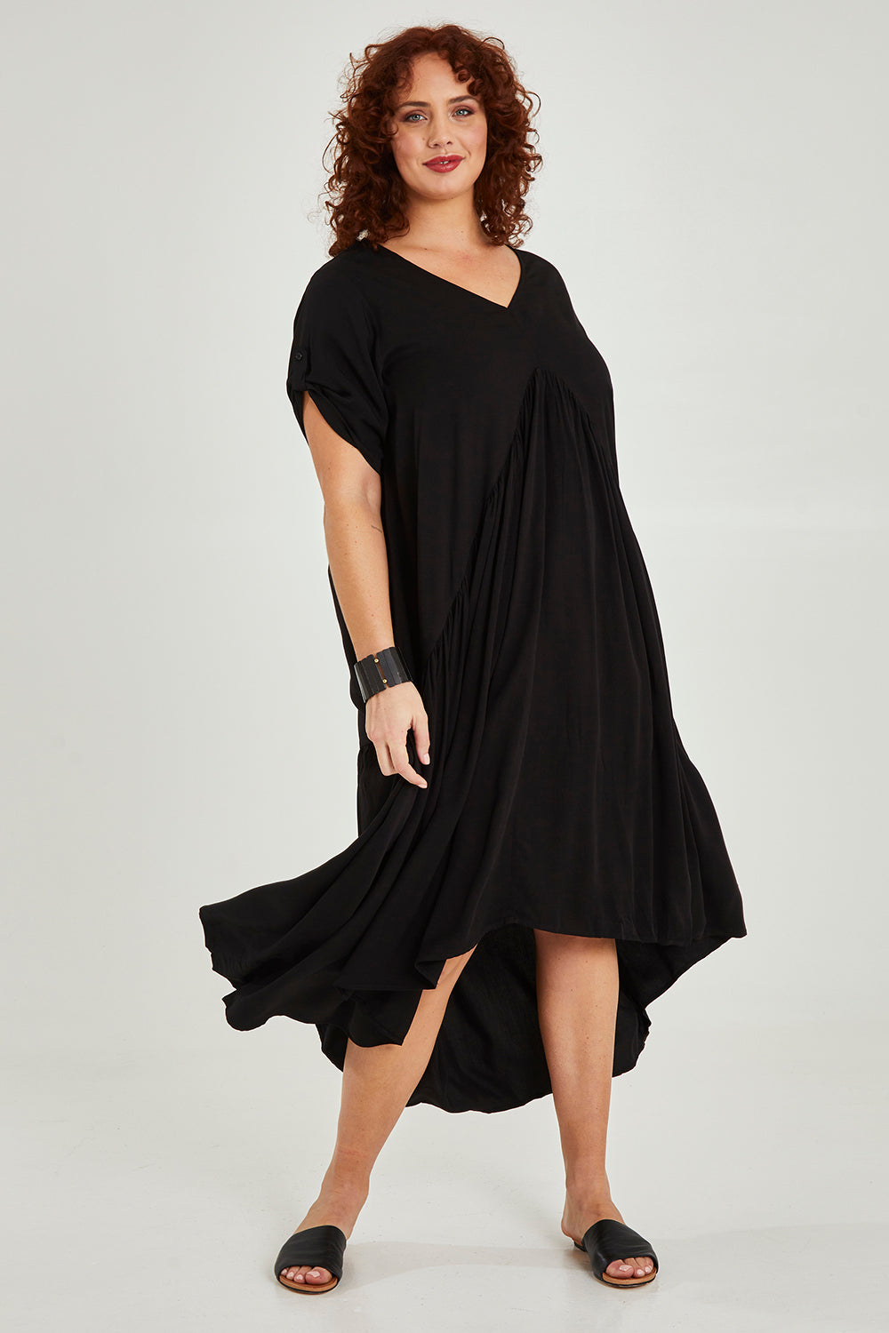 Model Maddy wearing the Short Sleeve Peak Maxi Dress in colour Black (Black), from the front, showing the whole outfit