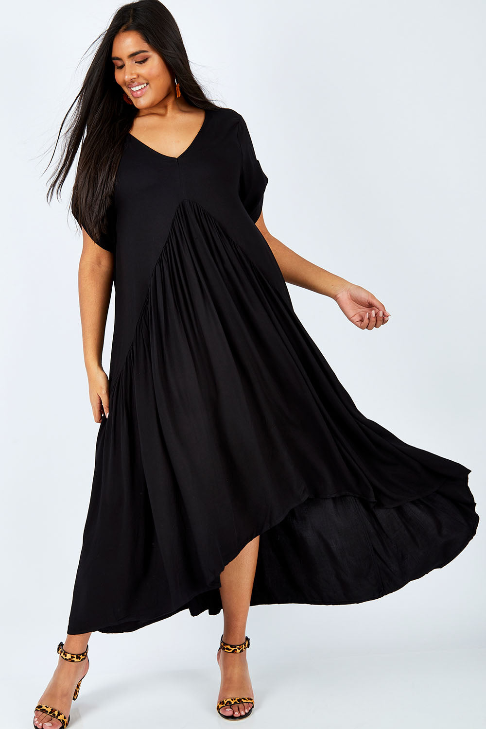 Model Shanaya wearing the Short Sleeve Peak Maxi Dress in colour Black (Black), from the front, showing the whole outfit