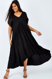 Model Shanaya wearing the Short Sleeve Peak Maxi Dress in colour Black (Black), from the front, showing the whole outfit