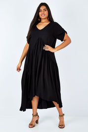 Model Shanaya wearing the Short Sleeve Peak Maxi Dress in colour Black (Black), from the front, showing the whole outfit