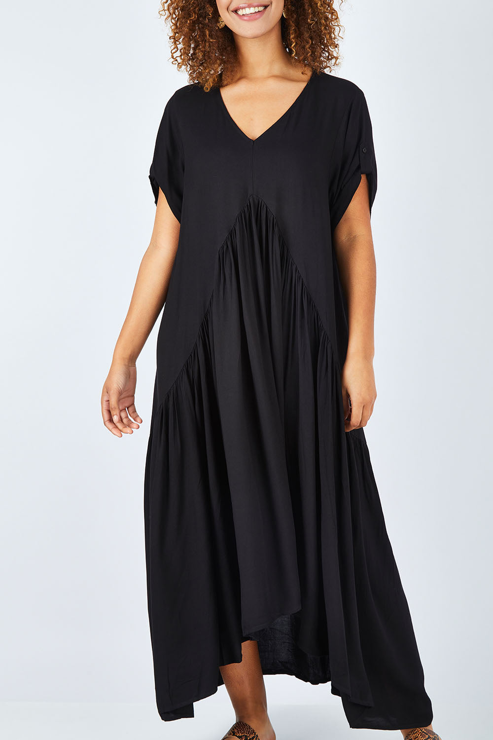 Model Summer wearing the Short Sleeve Peak Maxi Dress in colour Black (Black), from the front, cropped image