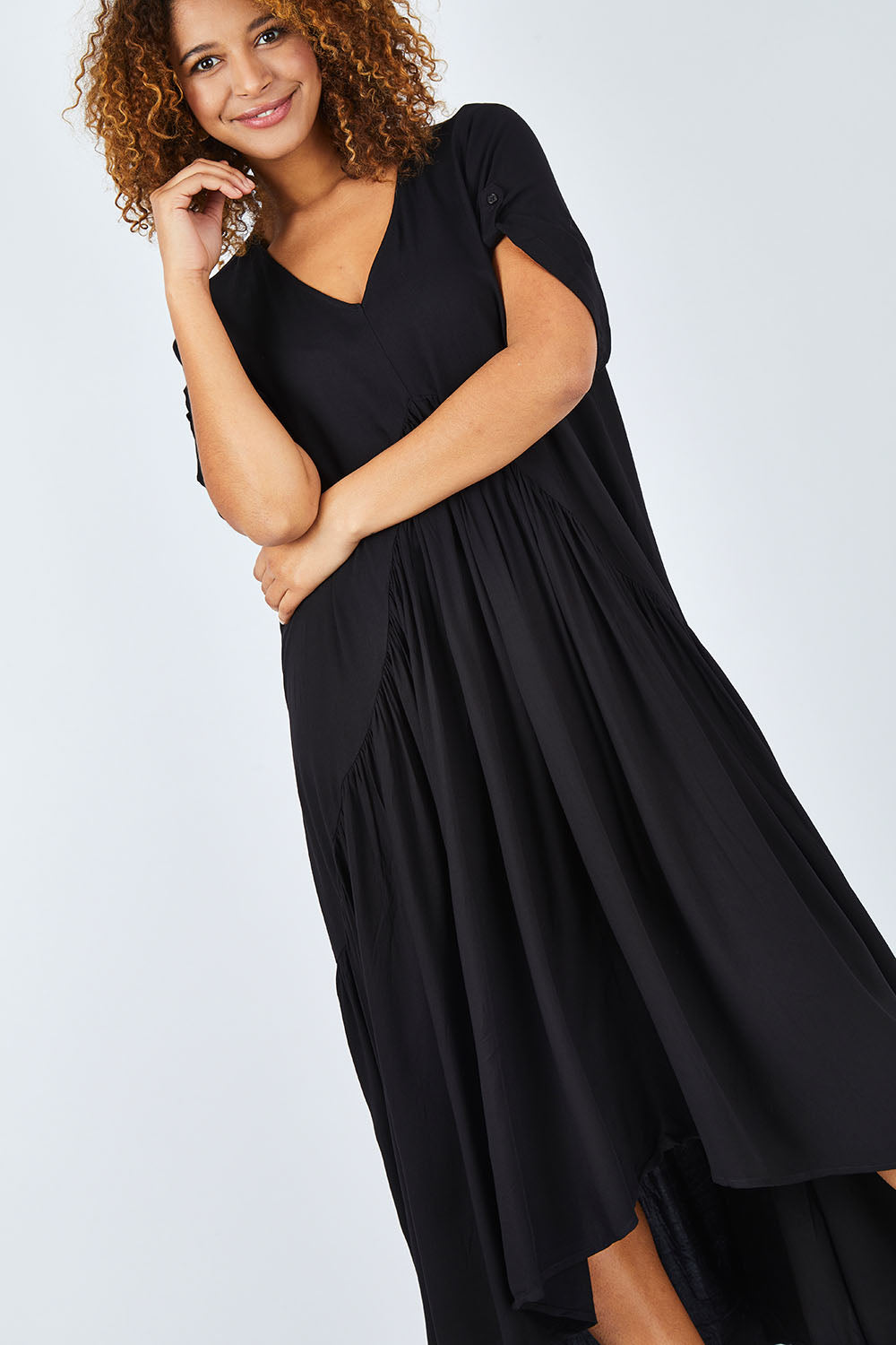 Model Summer wearing the Short Sleeve Peak Maxi Dress in colour Black (Black), from the front, cropped image