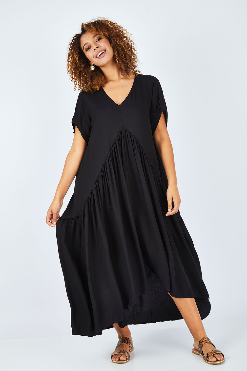 Model Summer wearing the Short Sleeve Peak Maxi Dress in colour Black (Black), from the front, showing the whole outfit