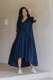 A model wearing the Short Sleeve Peak Maxi Dress in colour Navy (Blue), from the front, showing the whole outfit