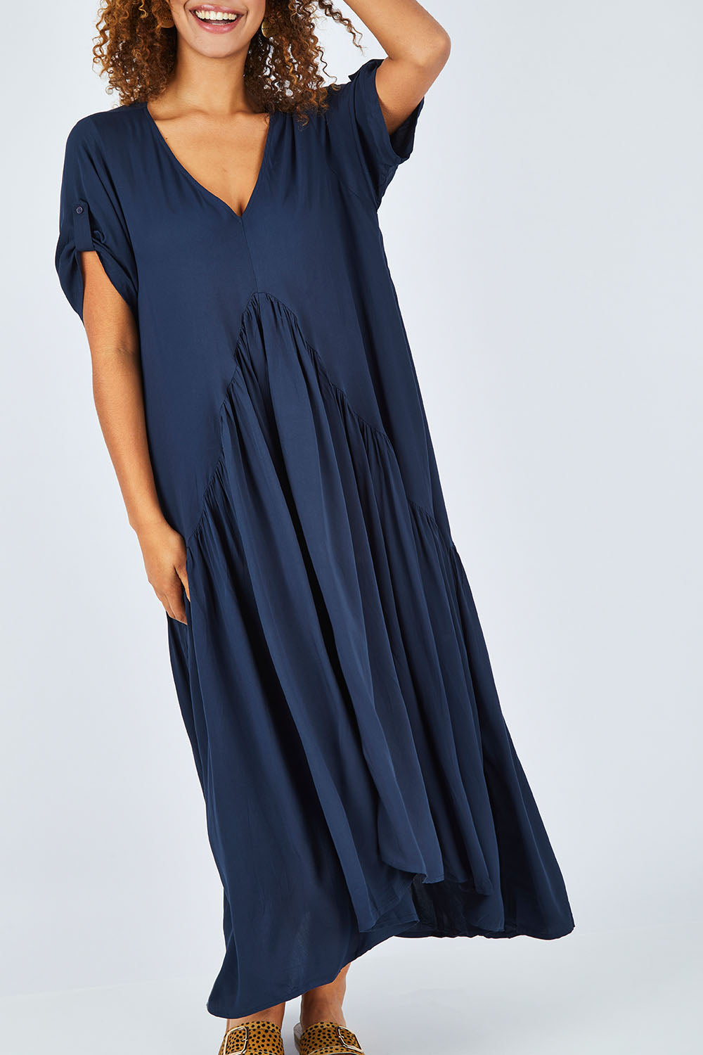Model Summer wearing the Short Sleeve Peak Maxi Dress in colour Navy (Blue), from the front, cropped image
